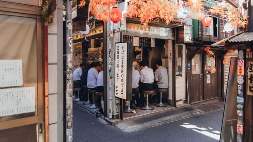 Tokyo After 5: Local Eats, Drinks & Culture Walk - Tsukishima Monja Town: cooking monja-yaki at the hotplate